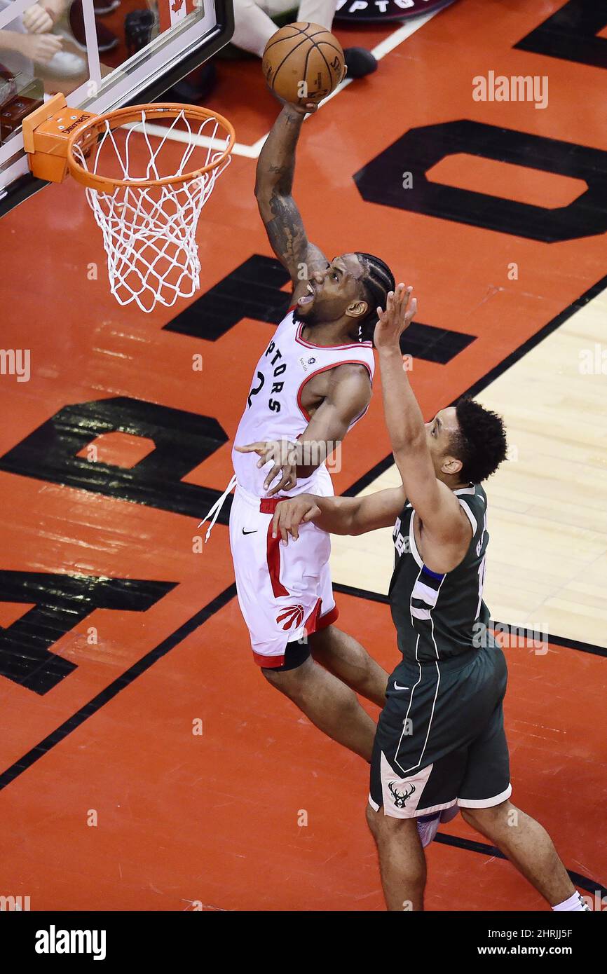 Toronto Raptors forward Kawhi Leonard (2) scores past Milwaukee Bucks guard Malcolm Brogdon (13) during the second overtime period of Game 3 NBA Eastern Conference finals basketball action in Toronto on Sunday, May 19, 2019. THE CANADIAN PRESS/Frank Gunn Stock Photo