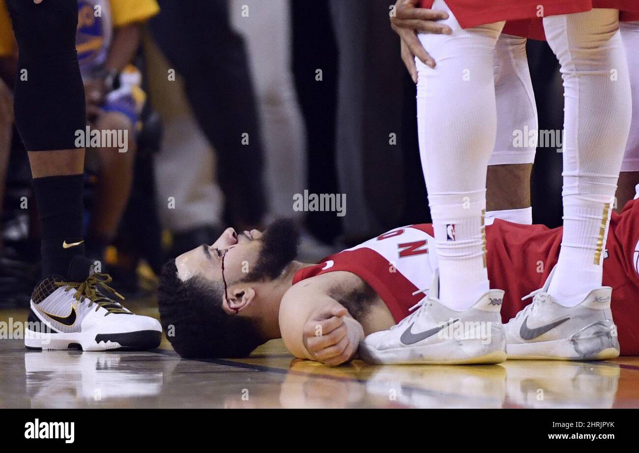 Toronto Raptors guard Fred VanVleet (23) lays on the floor as blood flows from below his eye during second half basketball action against the Golden State Warriors in Game 4 of the NBA Finals in Oakland, California on Friday, June 7, 2019. THE CANADIAN PRESS/Frank Gunn Stock Photo