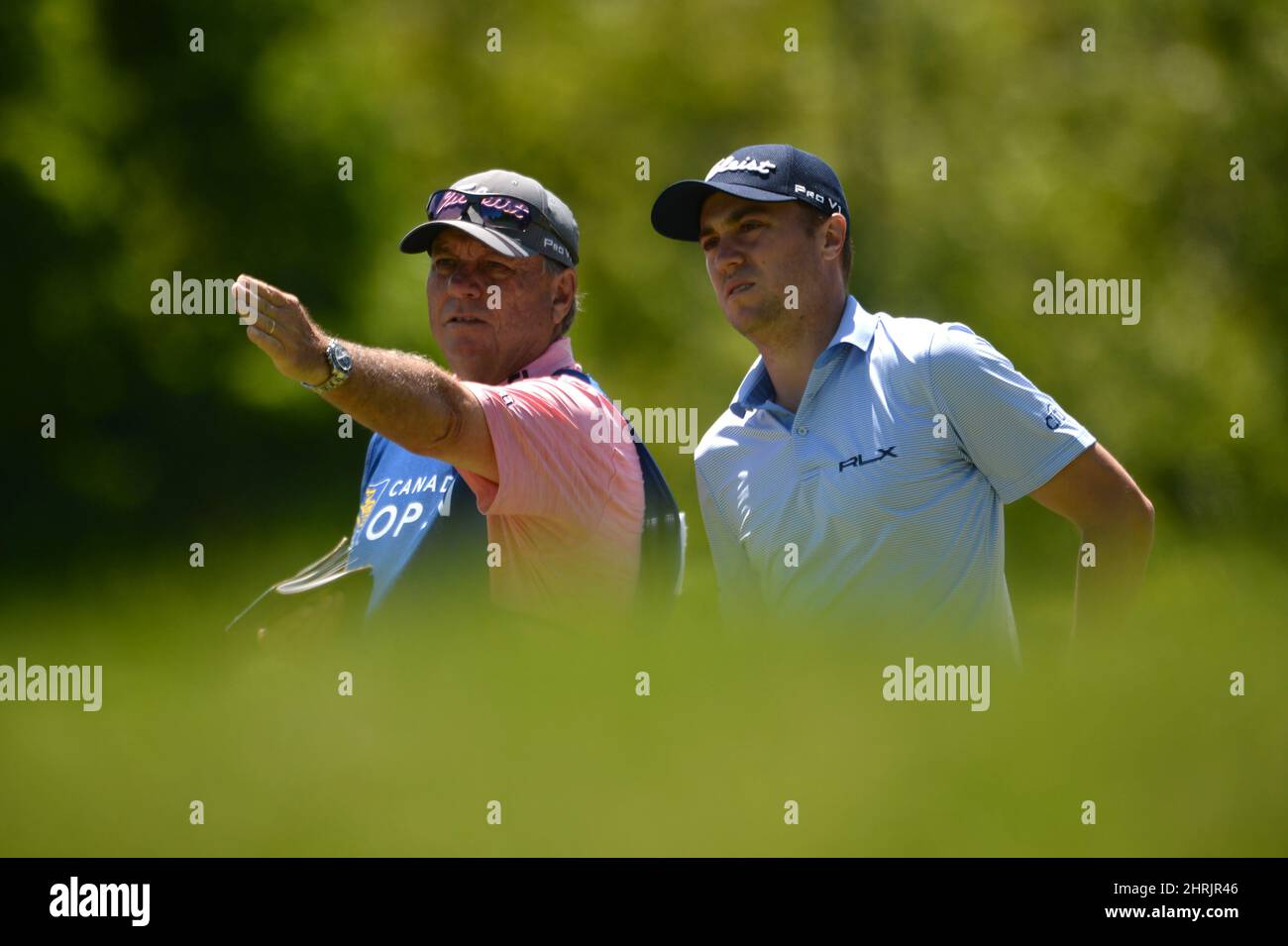 USA's Justin Thomas speaks with his caddy on the ninth hole during the