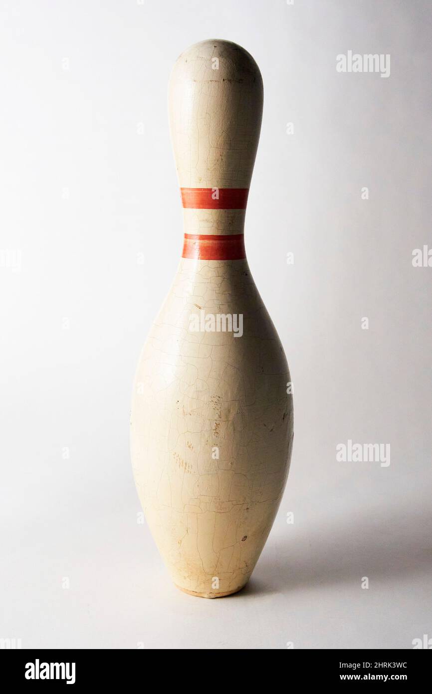Old wooden bowling pin on white background. Stock Photo
