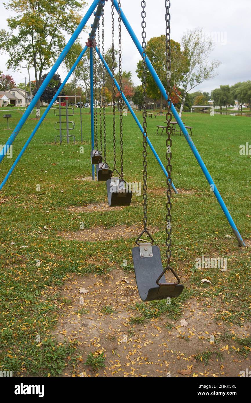 Empty swings in a neighborhood park. Stock Photo