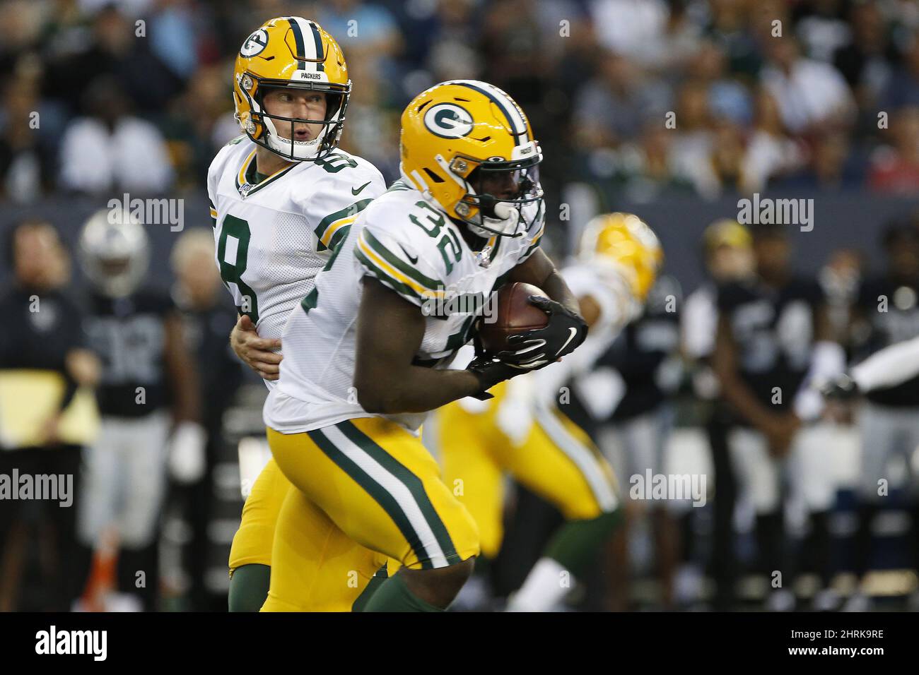 Green Bay Packers quarterback Tim Boyle (8) hands off to Tra Carson (32
