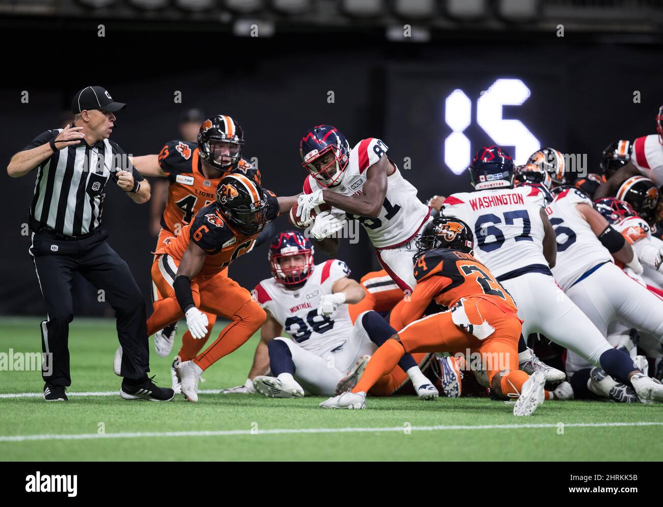 Montreal Alouettes' Eugene Lewis (87) is stopped at the goal line by B.C. Lions' T.J. Lee (6) and Chris Edwards (24) on a third and goal, during the second half of a CFL football game in Vancouver, on Saturday September 28, 2019. THE CANADIAN PRESS/Darryl Dyck Stock Photo