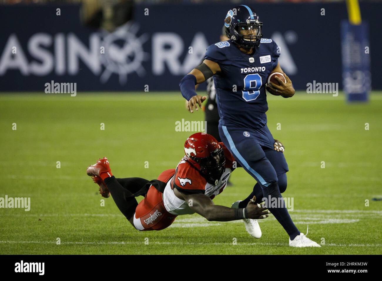 Calgary Stampeders defensive lineman Anthony Johnson (95) narrowly misses a tackle on Toronto Argonauts quarterback James Franklin (8) during second half of CFL action in Toronto on Sept. 20, 2019. James Franklin says taking over as No. 1 quarterback for the Toronto Argonauts late in a tough season isn't easy. After spending much of the year sidelined with a hamstring injury, the 28-year-old will get his third start of 2019 on Saturday when the Argos (2-11) take on the B.C. Lions (4-10) in Vancouver. Despite limited field time, he's completed 69-of-101 attempts this year, amassing 790 passing  Stock Photo