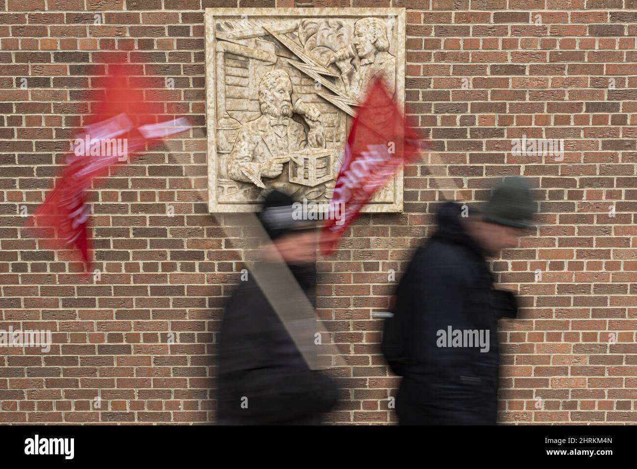 Picketing SaskTel employees walk along a picket line near a SaskTel