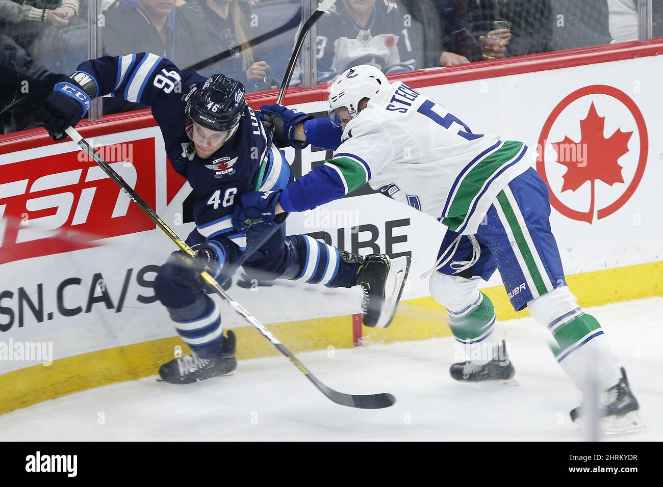 Winnipeg Jets' Joona Luoto (46) gets checked by Vancouver Canucks' Troy Stecher (51) during third period NHL action in Winnipeg, Friday, Nov. 8, 2019. THE CANADIAN PRESS/John Woods Stock Photo