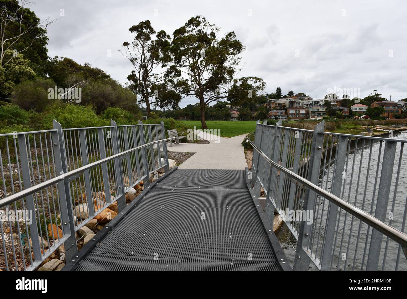 Natural view of a walkway with metal railings in a park Stock Photo - Alamy