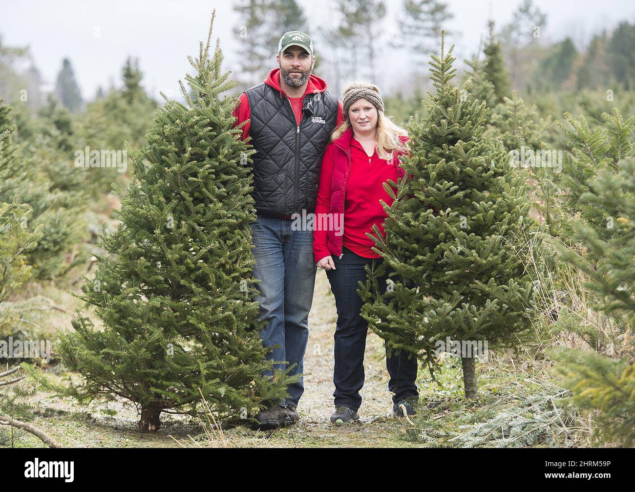 Quinn Farm coowners Phil and Stephanie Quinn pose next to Christmas
