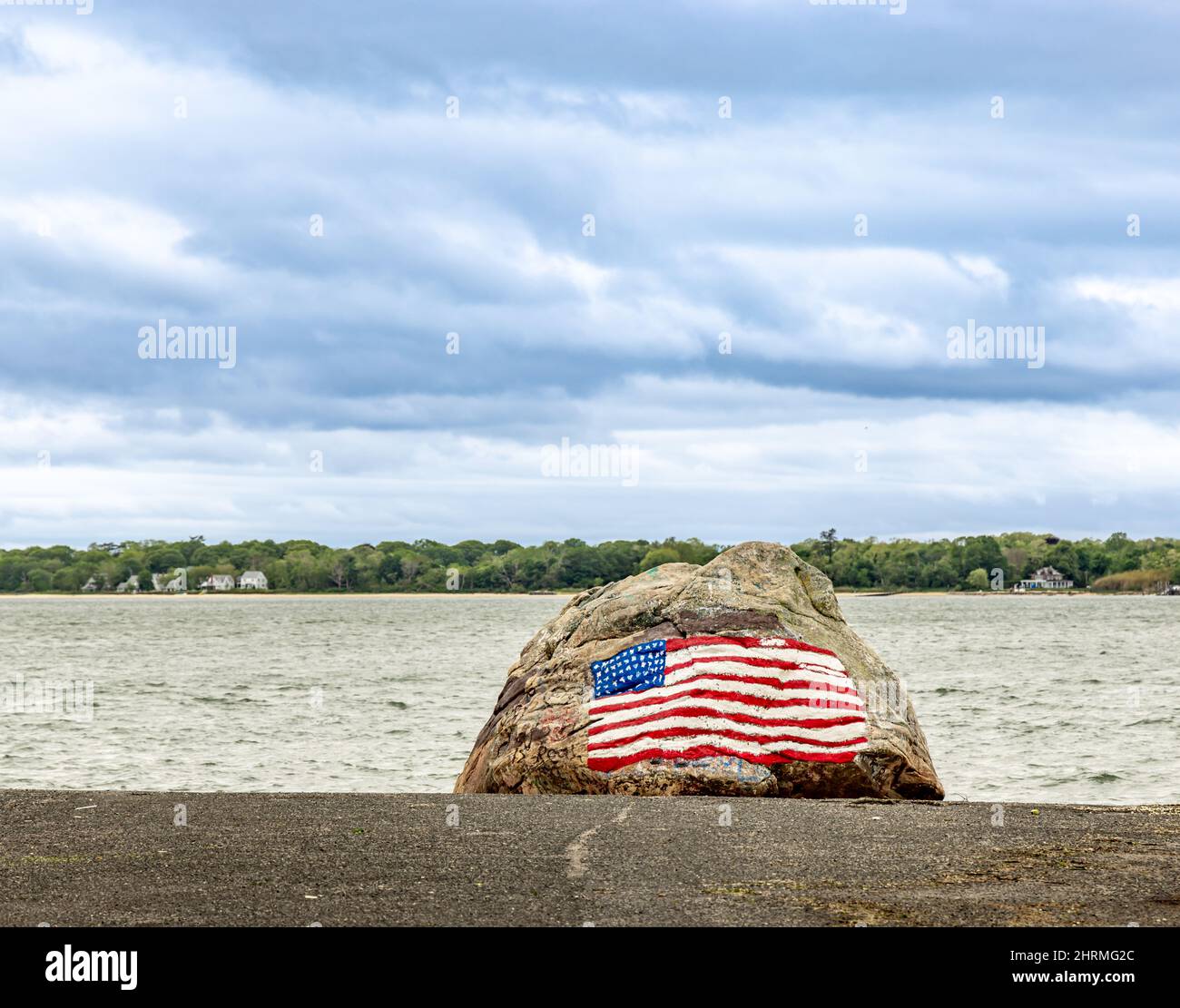 An American flag painted on a large boulder in Shelter Island, NY Stock Photo