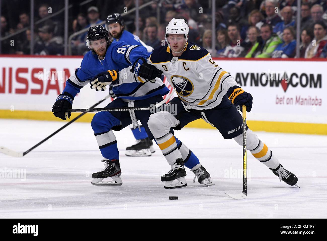 Winnipeg Jets' Kyle Connor (81) and Buffalo Sabres' Jack Eichel (9) fight for possession of the
