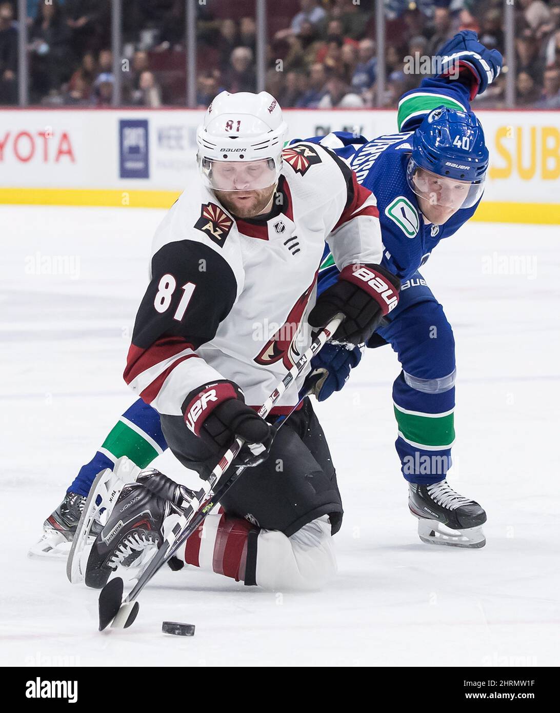 Arizona Coyotes' Phil Kessel (81) fights for control of the puck