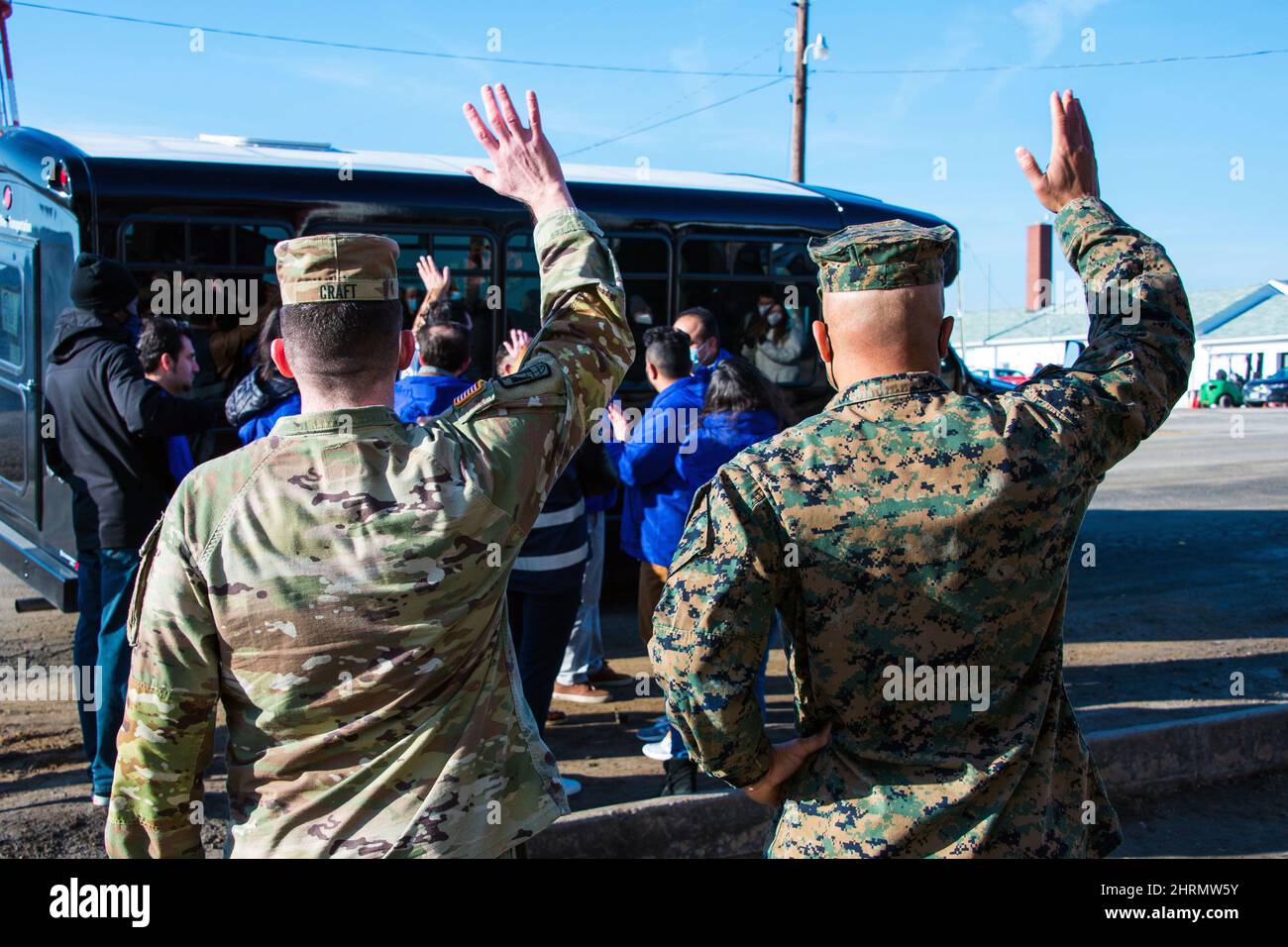 Usa. 1st Feb, 2022. U.S. Army Brig. Gen. Paul Craft, Commanding General of Task Force Pickett, and Col. Quintin Jones, Commanding Officer of 23rd Marine Regiment, wave goodbye to Afghan evacuees departing Safe Haven Pickett. This group of evacuees are the final to leave the safe haven and are settling in various communities across the USA. The Department of Defense, through U.S. Northern Command, and in support of the Department of Homeland Security, is providing transportation, temporary housing, medical screening, and general support for at least 50,000 Afghan evacuees at suitable facil Stock Photo