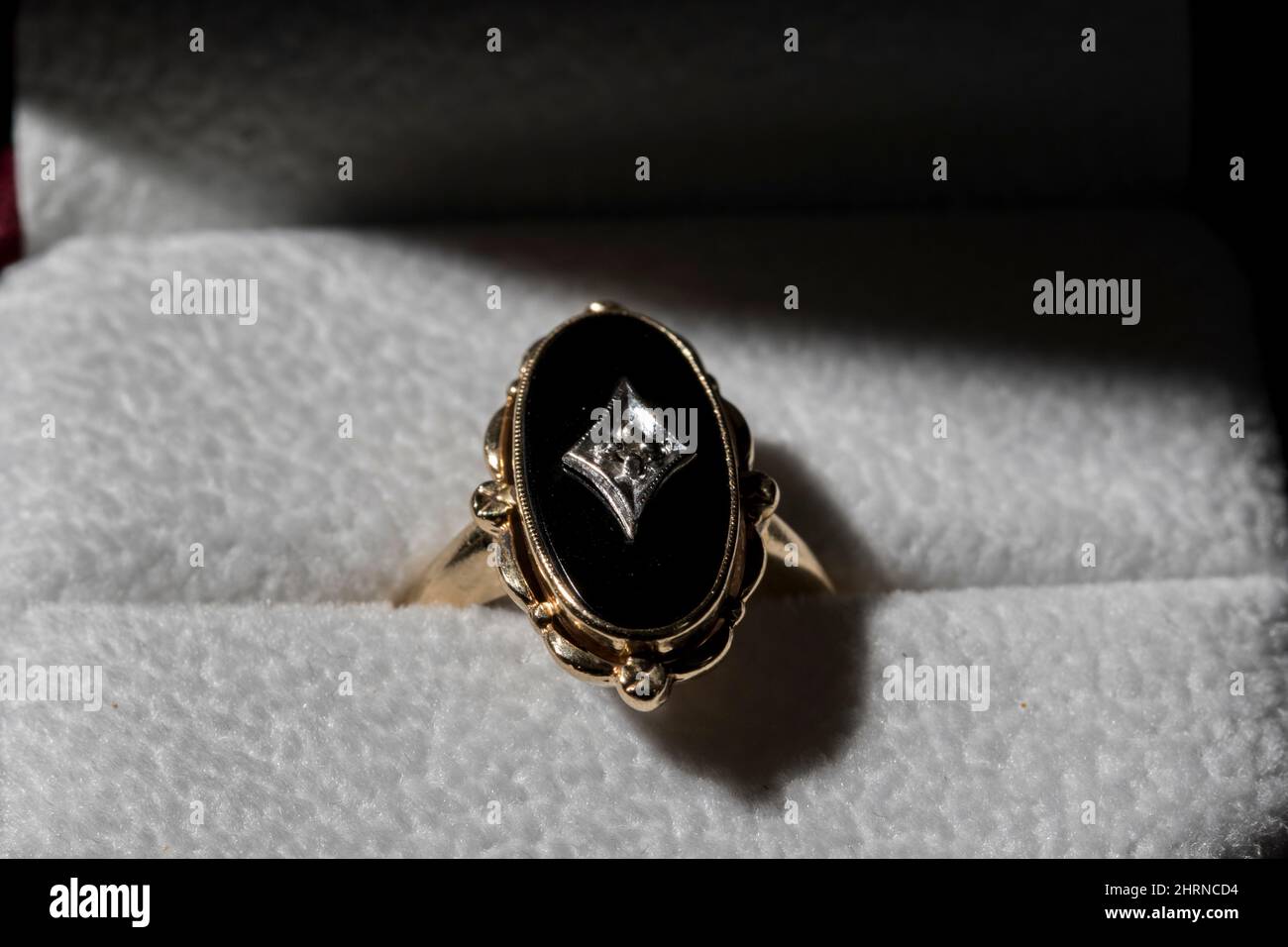 Retro black onyx diamond ring yellow gold ring with diamond center and onyx stone. Stock Photo