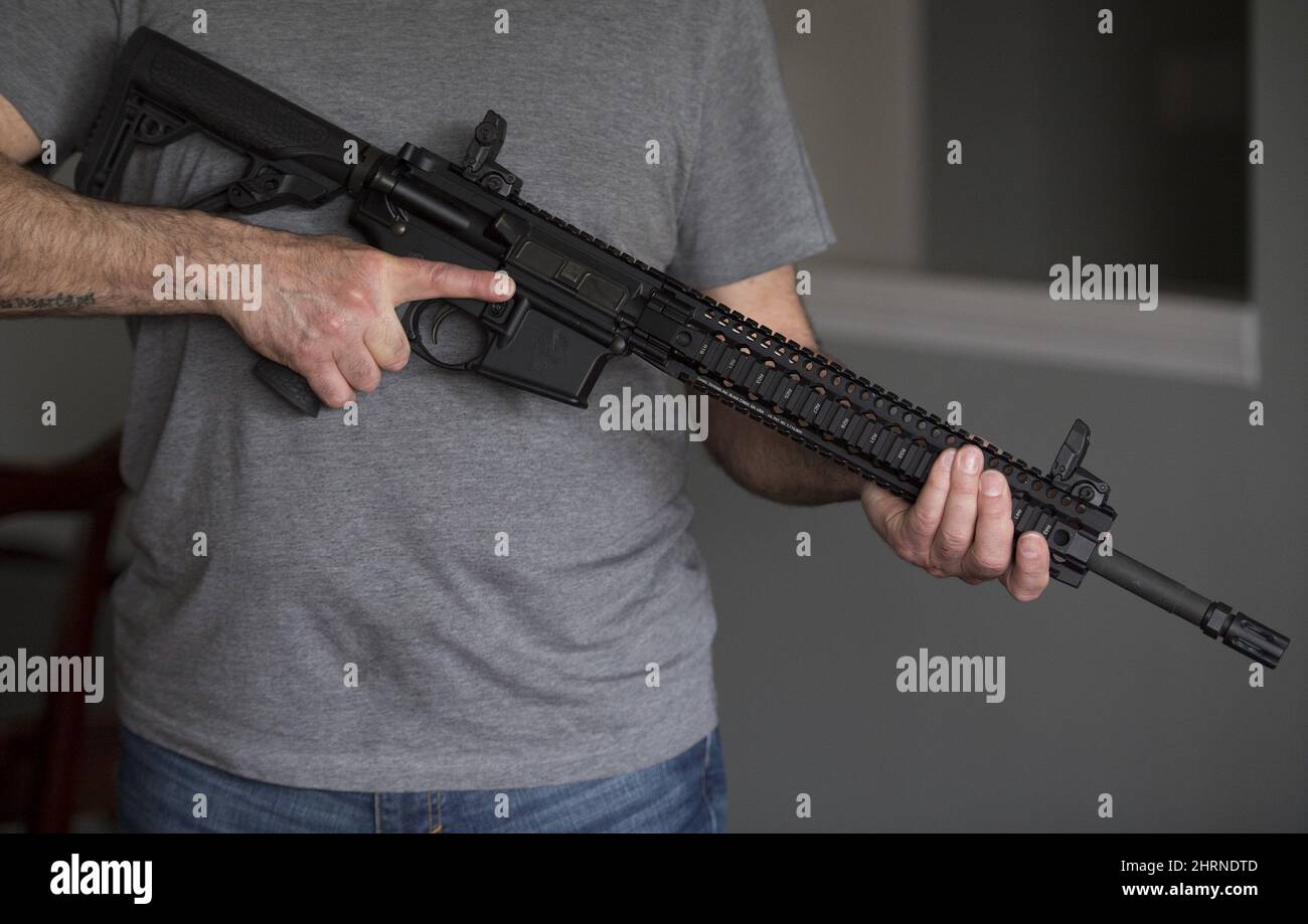 A restricted gun licence holder holds a AR15 at his home in Langley, B