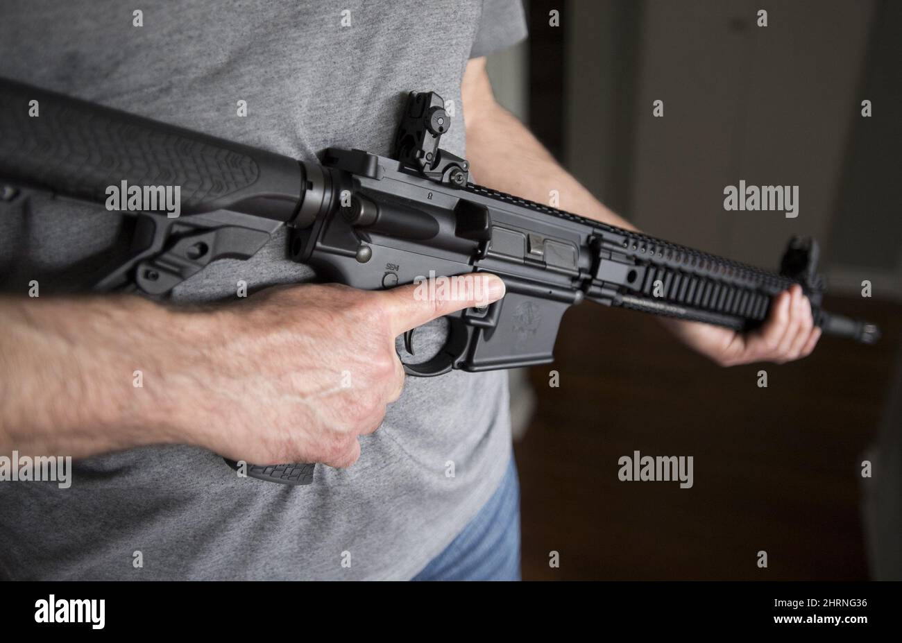 A restricted gun licence holder holds a AR15 at his home in Langley, B