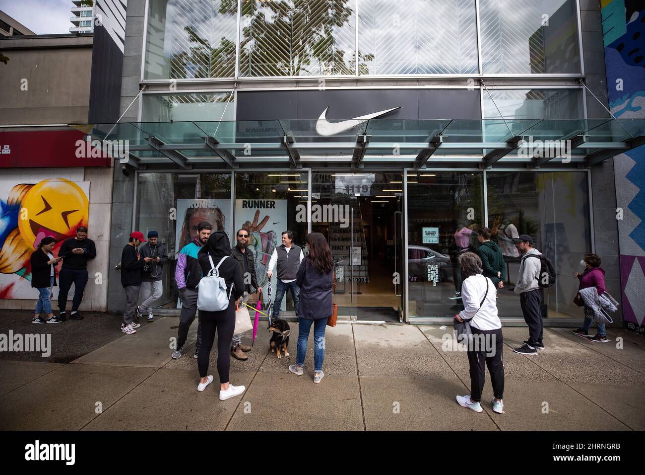 People wait to enter a Nike store on its first weekend open after a lengthy  closure