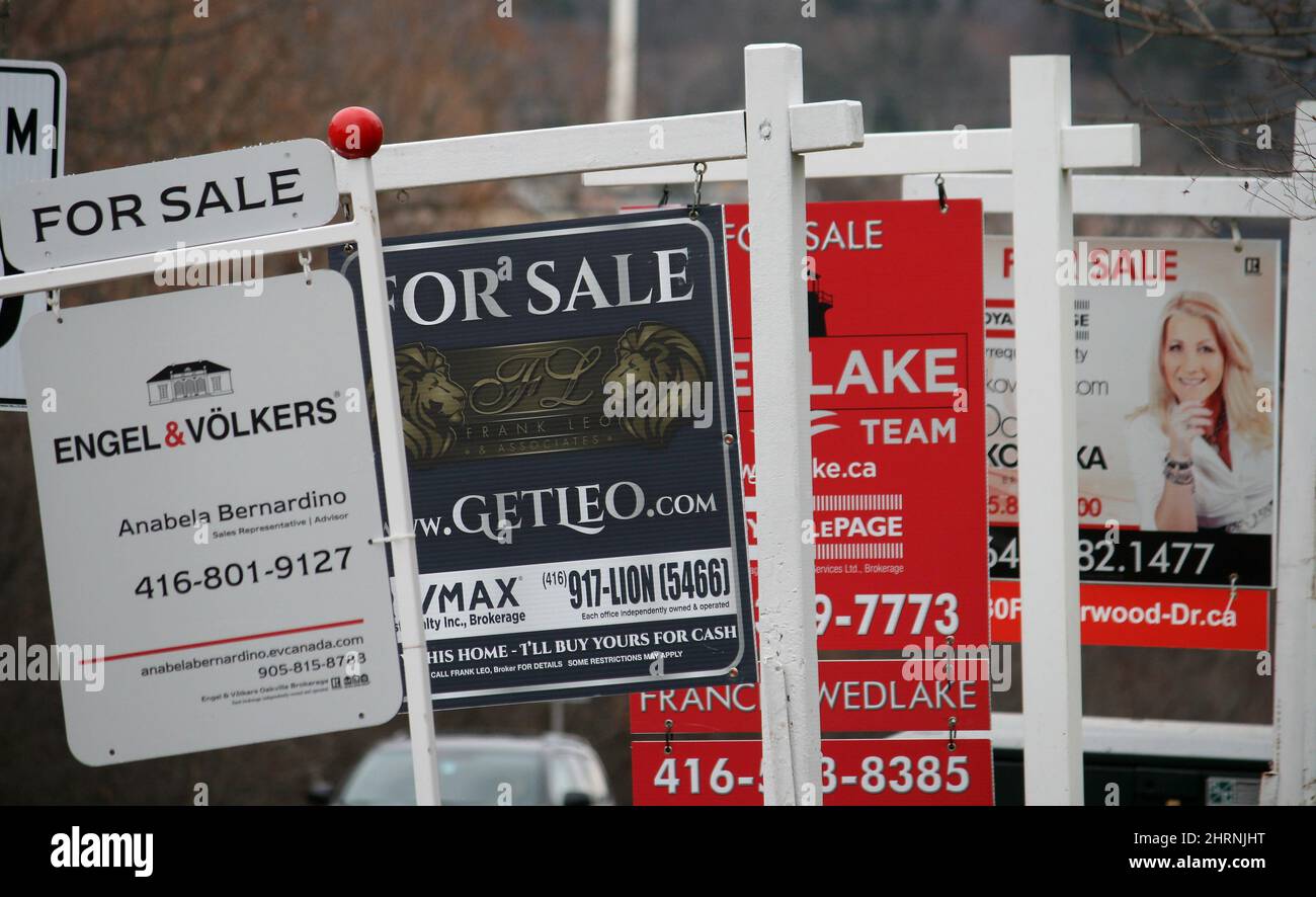 Real estate for sale signs are shown in Oakville, Ont. on Saturday, Dec