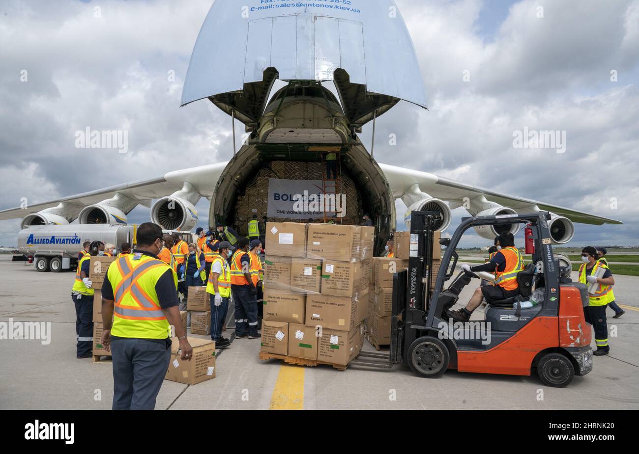 Workers unload the Antonov AN225 after it arrived with medical supplies