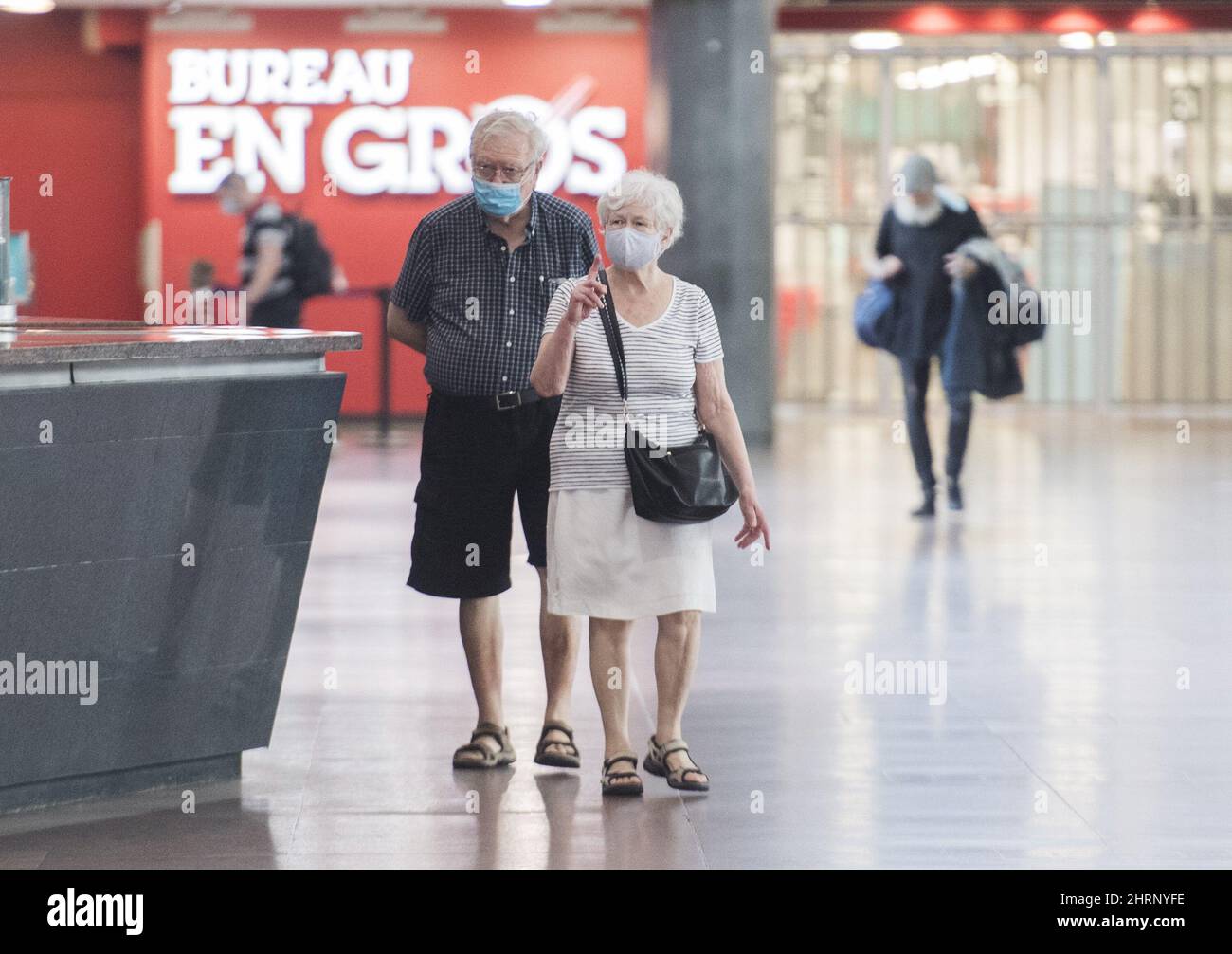 People wear face masks as they walk through Central Station in Montreal