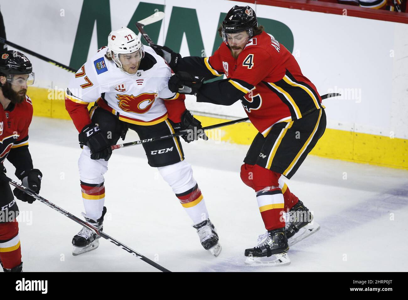 Calgary Flames' Rasmus Andersson, right, checks Mark Jankowski during a ...