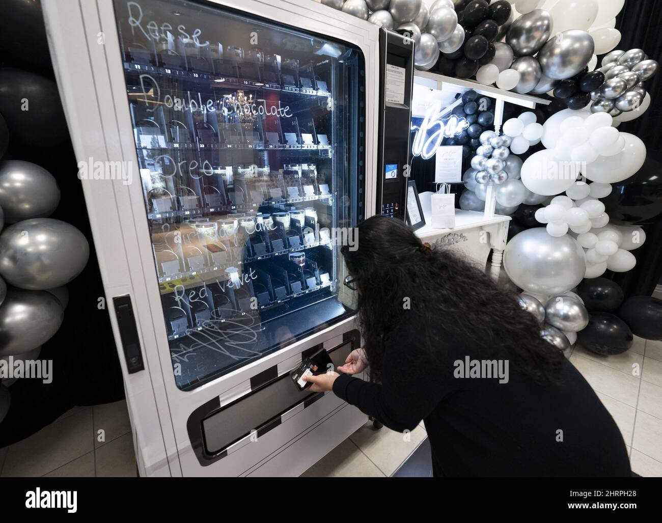 Customer Amrit Douhlani purchases a cake in a jar from the Jar Bar