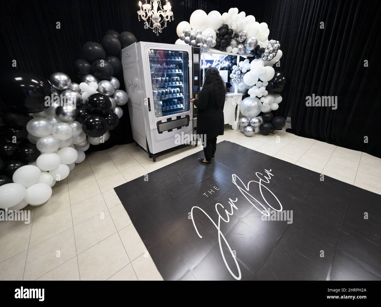 Customer Amrit Douhlani purchases a cake in a jar from the Jar Bar