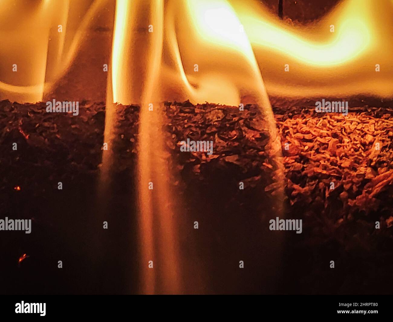 Closeup shot of burning woods on a brick fireplace Stock Photo