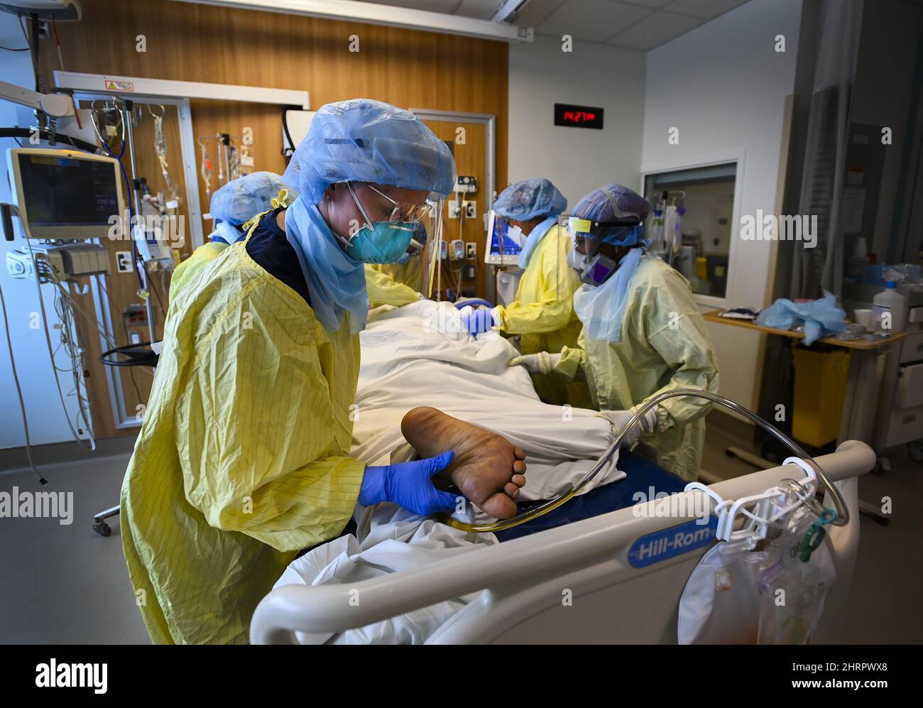 Healthcare workers turn a COVID19 patient in the ICU who is intubated