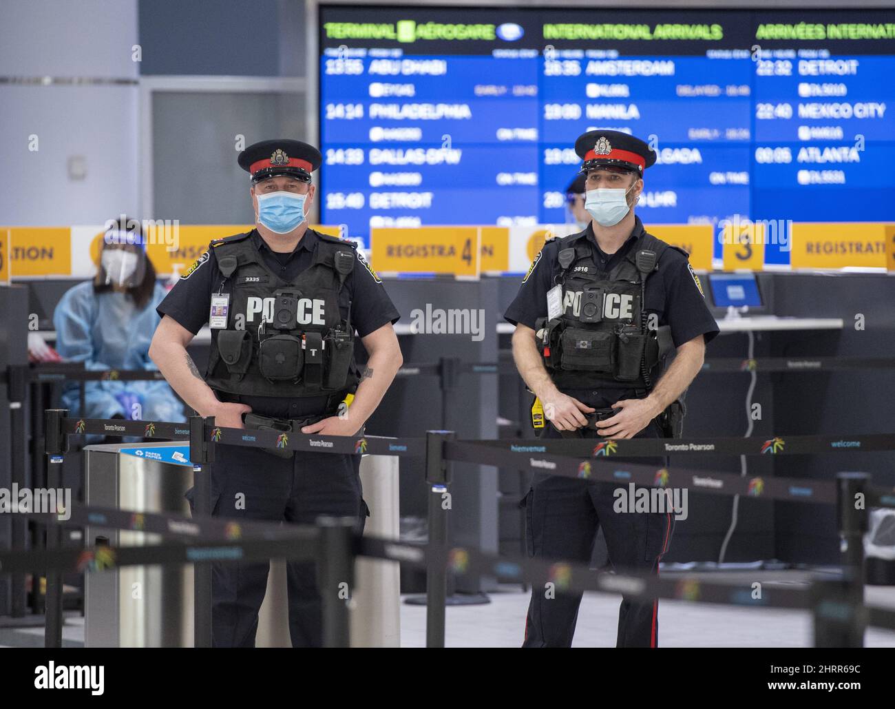 Police and workers wait for arrivals at the COVID19 testing centre in
