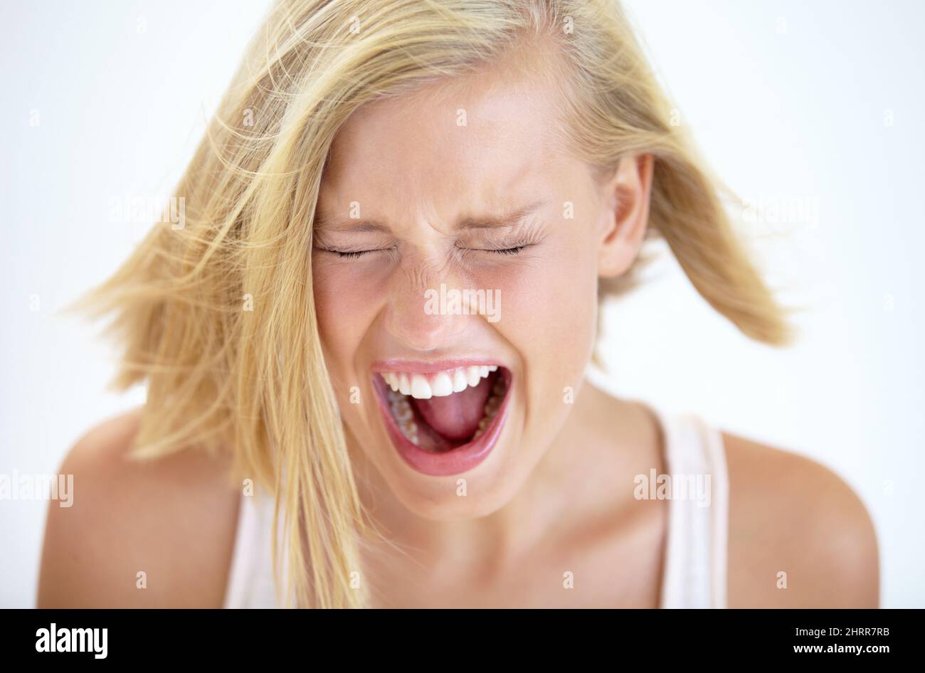 I cant take this anymore. A young woman shrieking with eyes closed. Stock Photo