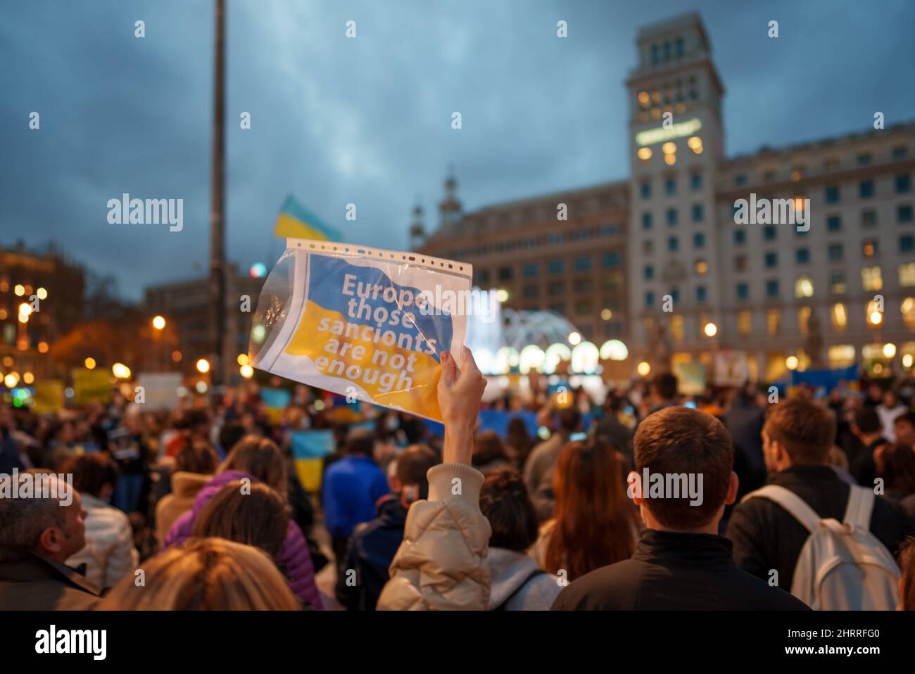 Barcelona, Spain - February 25, 2022: Protest against the war and russian aggressive Vladimir Putin politic. Ukrainians in Spain in defense of Ukraine on plaza Catalunya place. Sign says Europe those sanctions are not enough. Reportage editorial photo from Catalunya Stock Photo