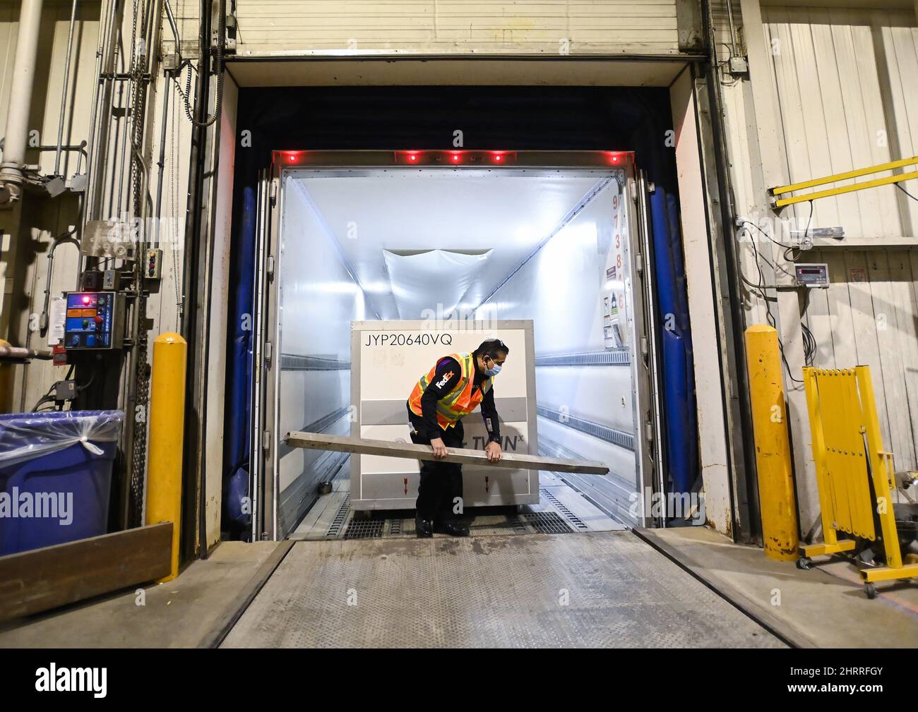 A FedEx worker loads the 255,600 doses of the Moderna COVID19 vaccine