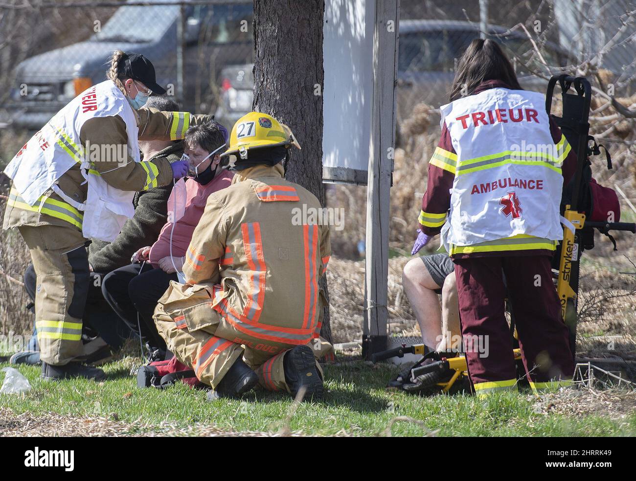 People receive treatment from paramedics following an apartment building following a fire in Montreal, Sunday, April 11, 2021. THE CANADIAN PRESS/Graham Hughes Stock Photo