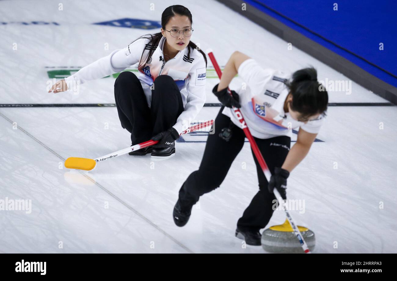 South Korea skip EunJung Kim, left, makes a shot against the United