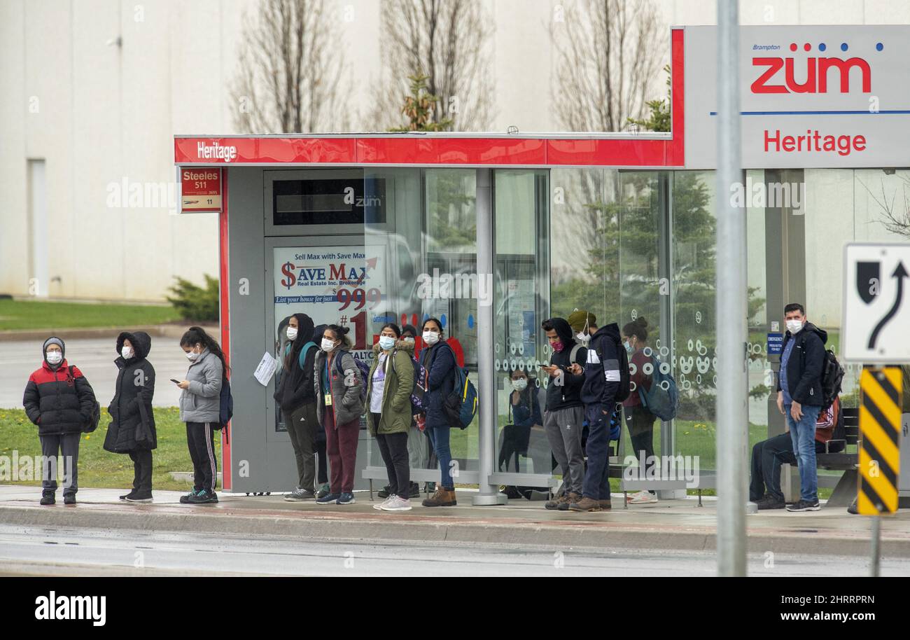 Passengers wait for a Brampton ZUM bus outside an Amazon Fulfillment Warehouse in Brampton