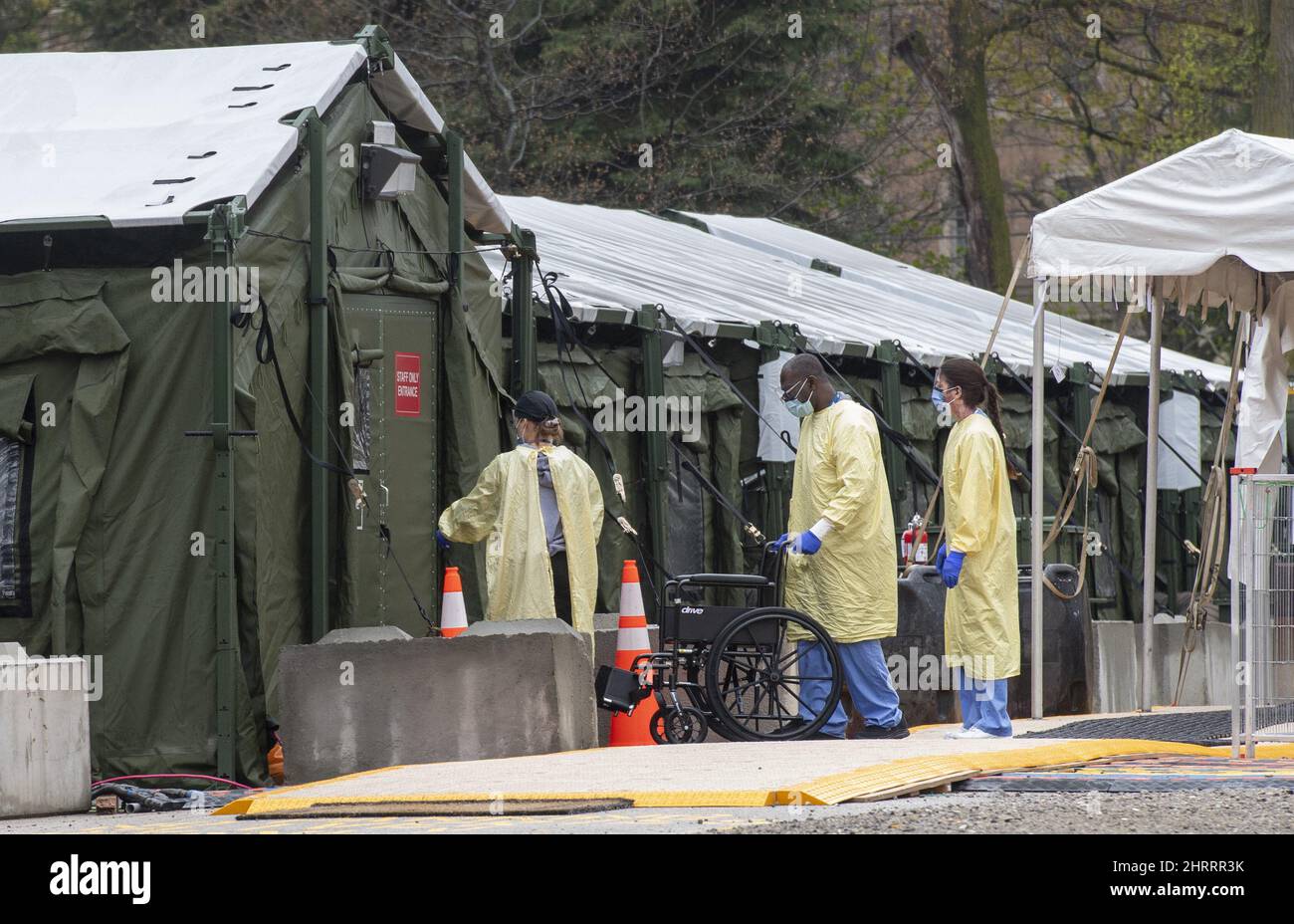 Staff enter the mobile field hospital in the parking lot at Sunnybrook