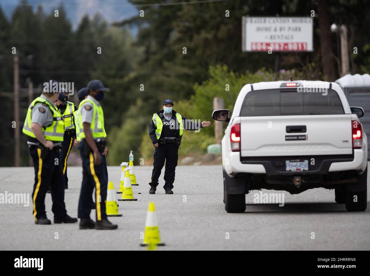 RCMP officers stop a motorist at a COVID19 travel checkpoint on the