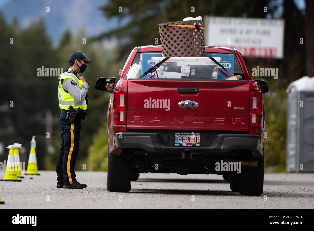 An RCMP officer speaks with a motorist at a COVID19 travel checkpoint