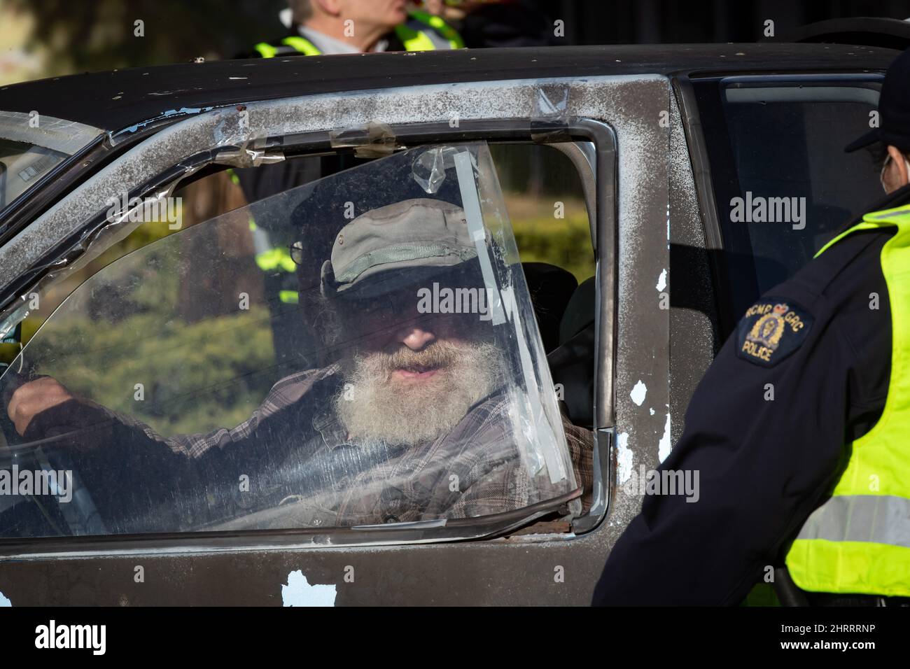 A motorist speaks to an RCMP officer at a COVID19 travel checkpoint on