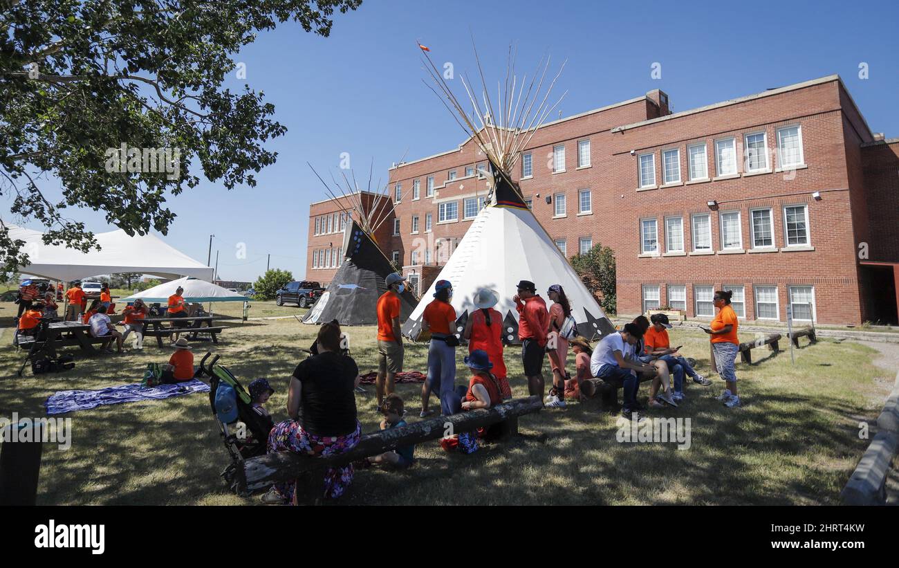 Siksika band members attend a gathering paying tribute to victims of residential schools at Old Sun Community College, site of a former residential school, on the Siksika Nation near Gleichen, Alta., Wednesday, June 30, 2021.THE CANADIAN PRESS/Jeff McIntosh Stock Photo