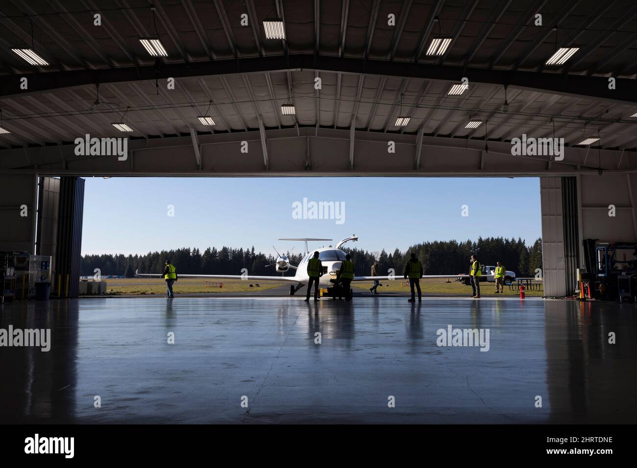 Arlington, Washington, USA. 25th February, 2022. Members of the ground crew roll the Alice prototype all-electric aircraft out of the hangar for a taxi test at Eviation headquarters in Arlington Municipal Airport. Eviation expects to make the first flight of Alice in the upcoming weeks pending additional taxi and flight test preparations. Credit: Paul Christian Gordon/Alamy Live News Stock Photo