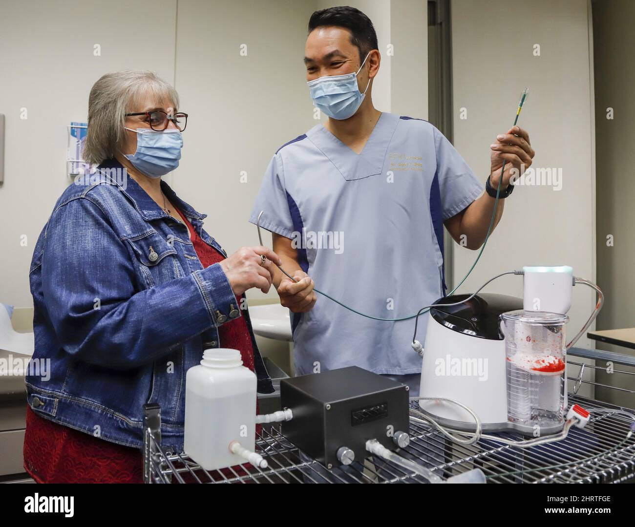 Brenda Crowell, left, and Dr. Jason Wong, display a CAT12 device, which