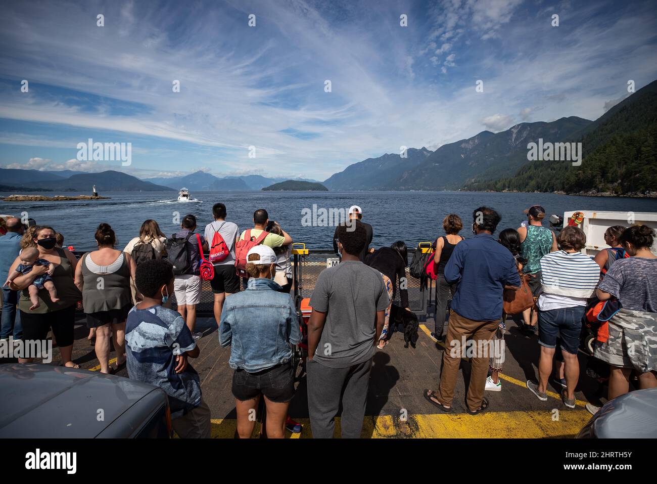 People stand on the vehicle deck of the B.C. Ferries vessel Queen of