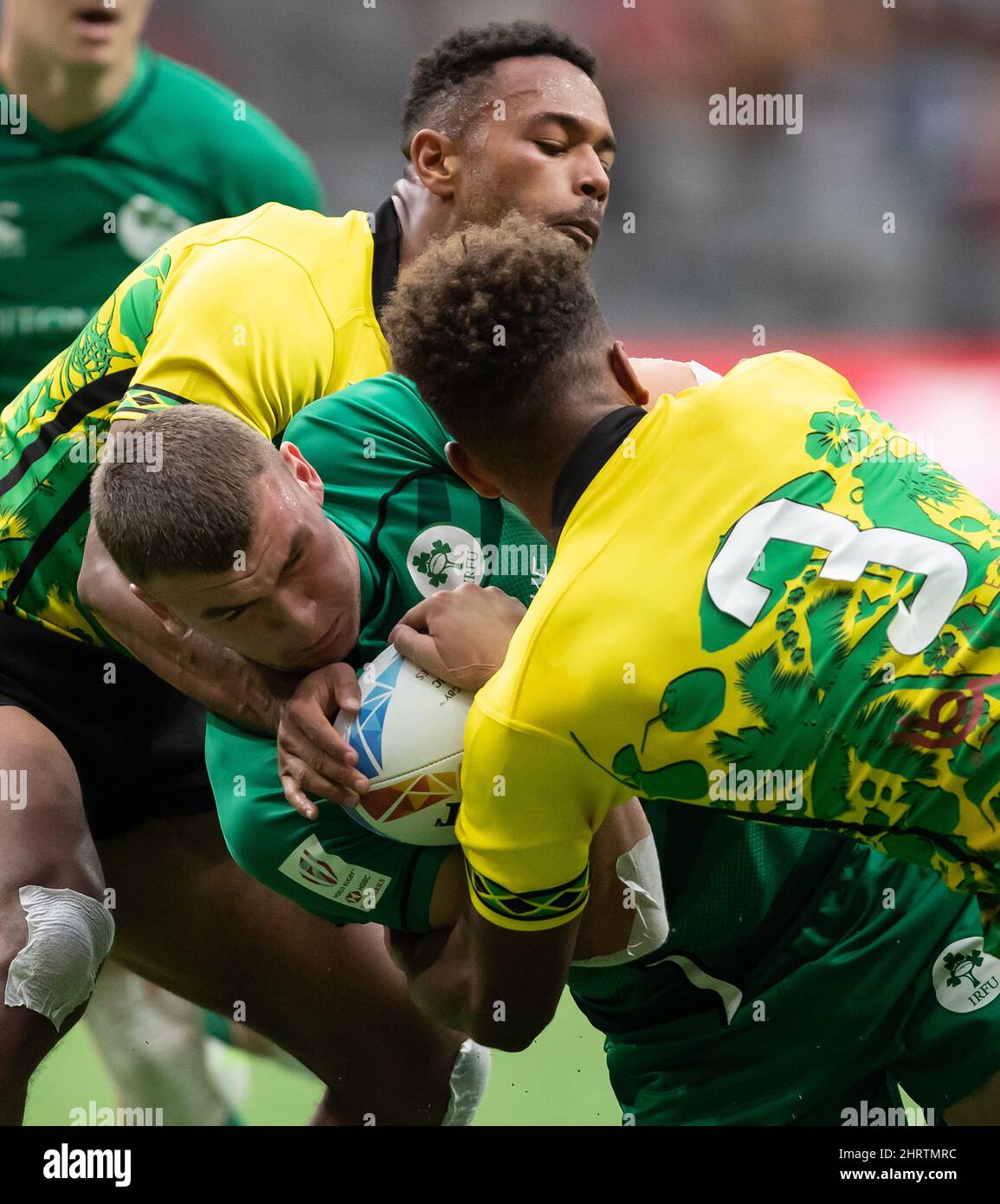 Ireland's Ben Moxham, front left, is tackled by Jamaica's Samuel Rees ...