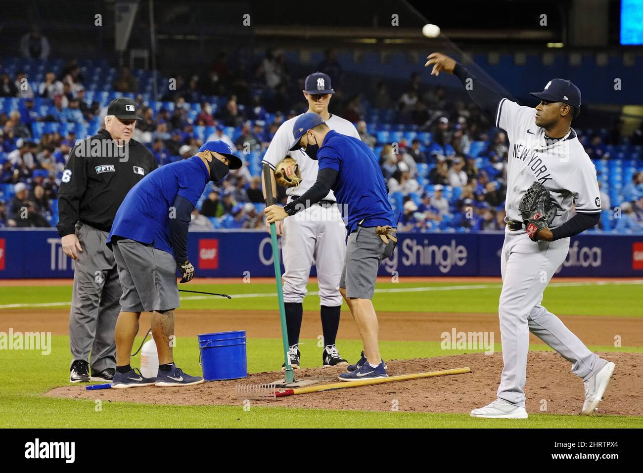 New York Yankees pitcher Luis Severino (40) tosses a ball as grounds crew members fix the pitching mound during eighth inning American League MLB baseball action against the Toronto Blue Jays in Toronto on Tuesday, September 28, 2021. THE CANADIAN PRESS/Frank Gunn Stock Photo