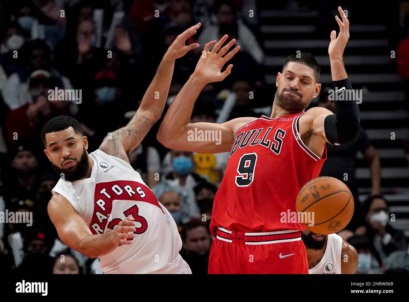 October 9, 2022, TORONTO, ON, CANADA: Chicago Bulls centre Nikola Vucevic  (9) dunks the ball, despite the defence of Toronto Raptors player Scottie  Barnes (4) during the first quarter of an NBA