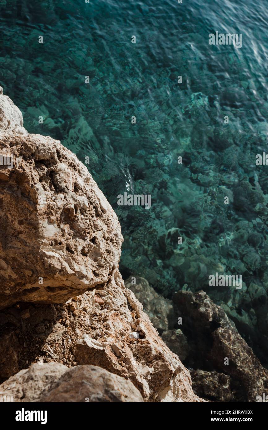 Blue sea water texture and rocks Stock Photo - Alamy