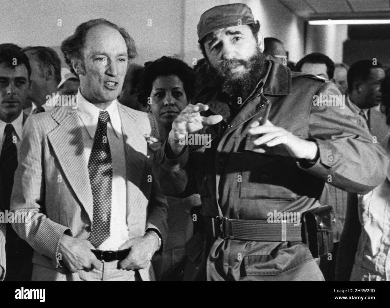 Former prime minister Pierre Trudeau looks on as Cuban President Fidel Castro gestures during a visit ot a Havana housing project. Stock Photo