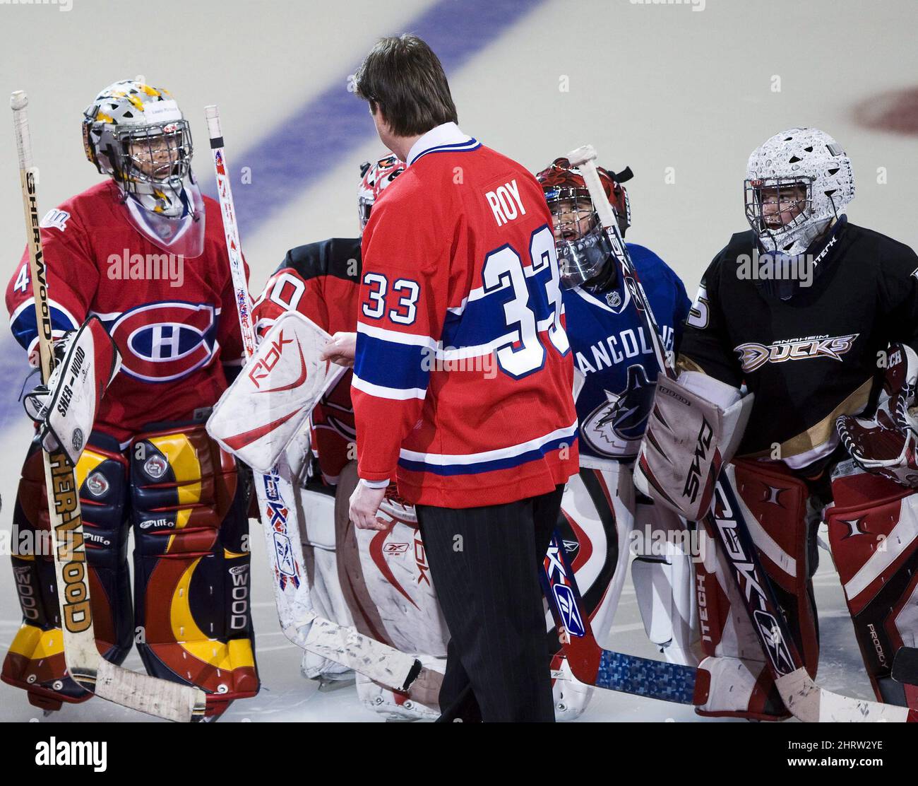 Former Montreal Canadiens goalie Patrick Roy, left, stands with