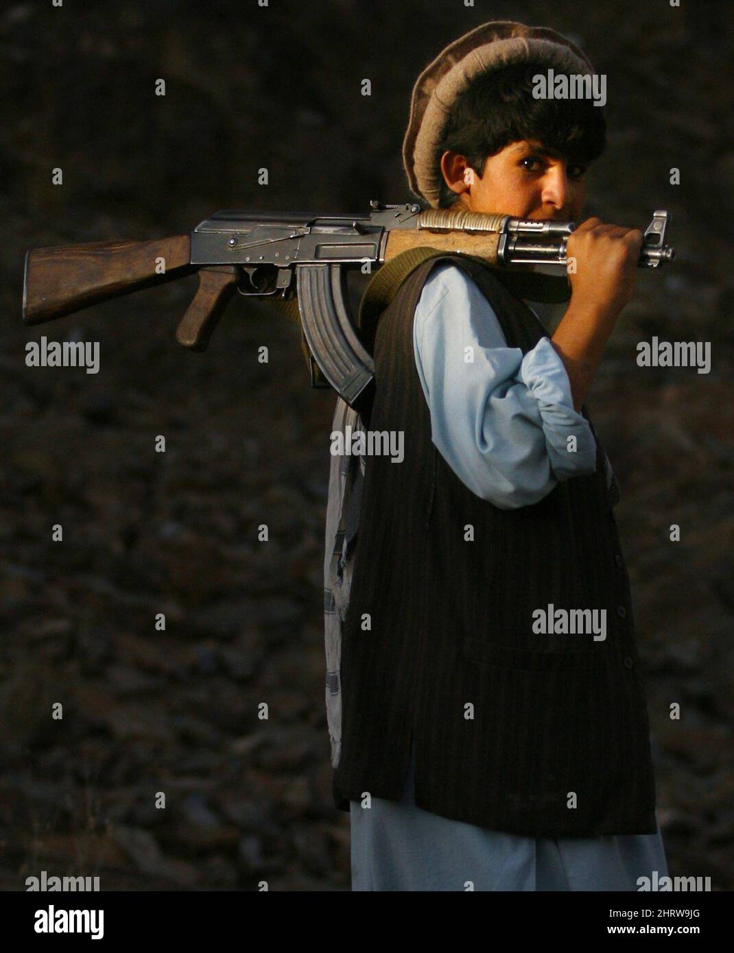 **FILE** This Sept. 11, 2003 file photo shows Esmad Ullah, an Afghan teenager now a soldier with Afghanistan's national Army and former Northern Alliance fighter, holding his AK-47 assault rifle over his shoulder as he walks down from an observation post outside Kabul, Afghanistan in this photo by Canadian Press photographer Tom Hanson. Award-winning Canadian Press photojournalist Hanson, a fierce champion of journalistic rights whose sometimes brusque manner belied a devoted husband with a gentle soul, died suddenly Tuesday after collapsing while playing hockey. (AP Photo/The Canadian Press,  Stock Photo